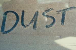 The word 'DUST' written on car rear windscreen following Saharan sand deposited in England by strong south easterly winds