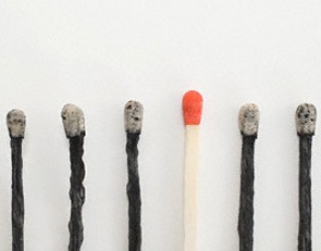 An unlit and burnt matches in a row